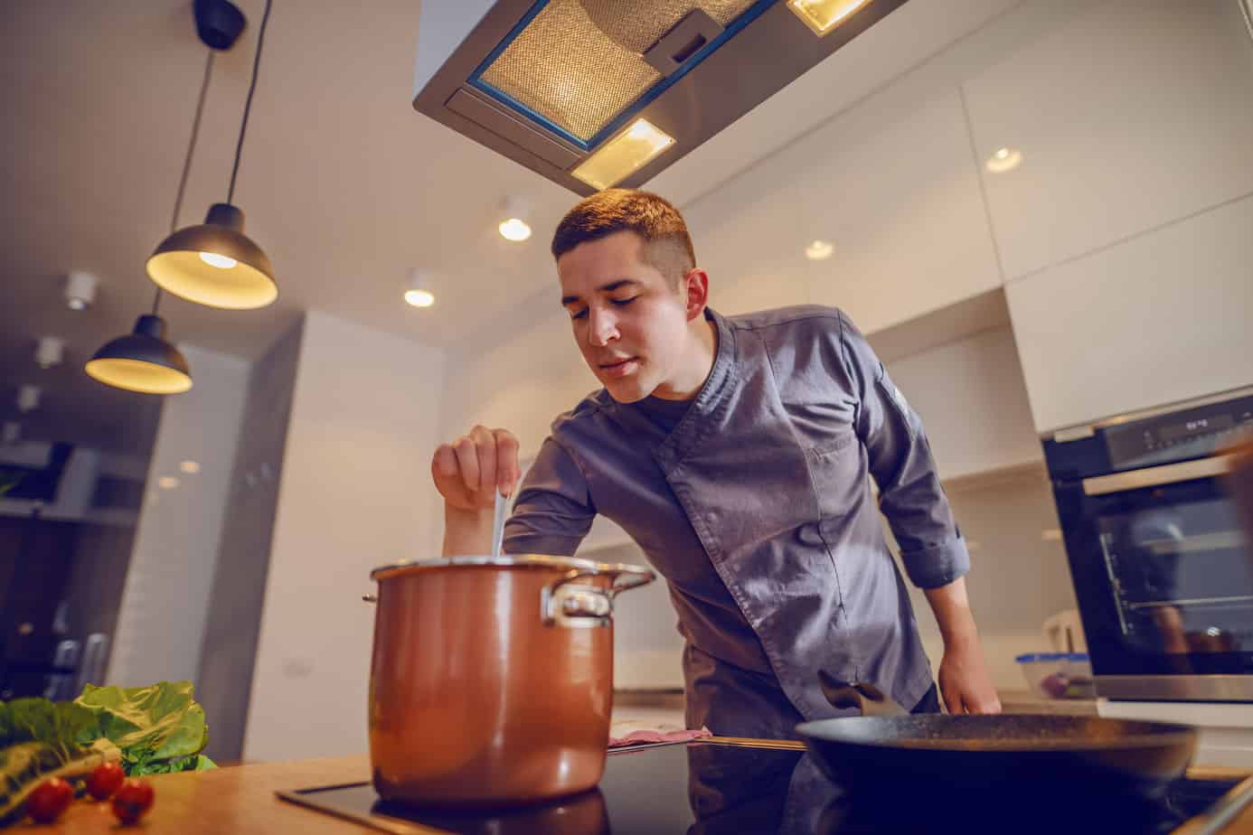 chef stirring a pot of stock made from leftover ingredients