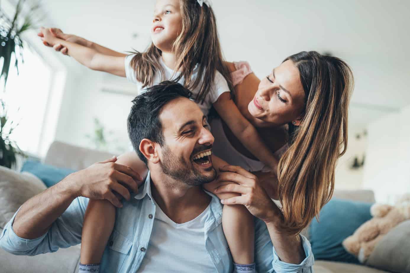 a happy couple and their daughter enjoying their special time together.