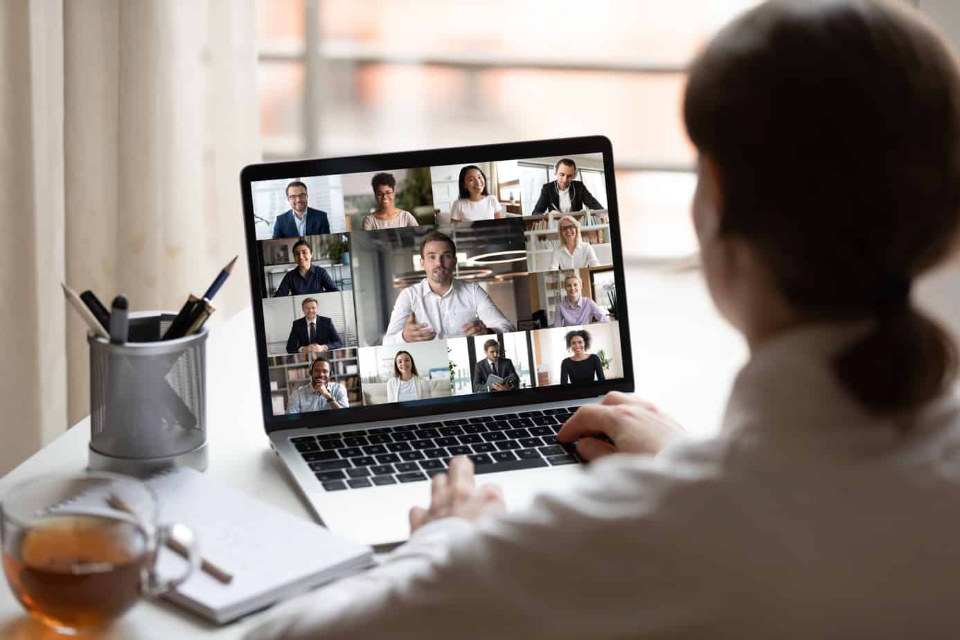 woman on a zoom call with 12 people.