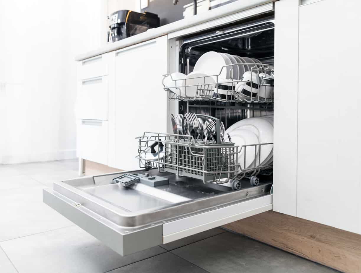 plates, silverware, and stainless steel cookware in a dishwasher.