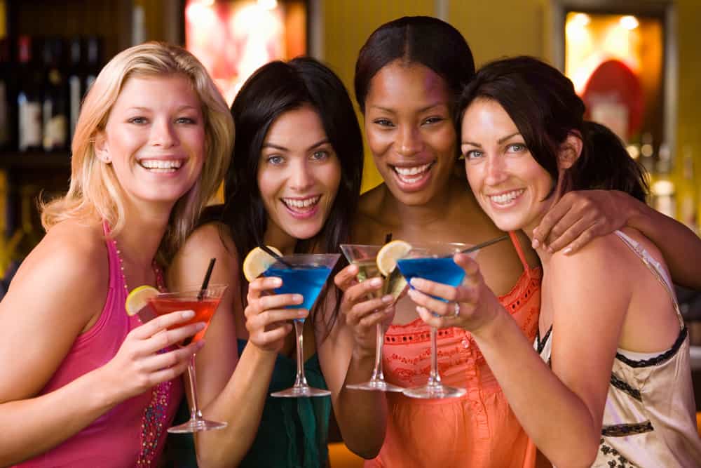 a group of friends enjoying girls night out with cocktails