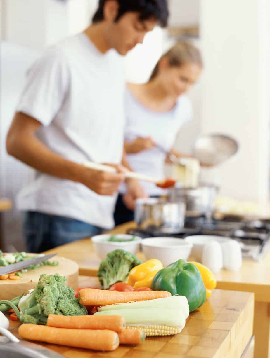 a couple cooking together to repurpose leftovers