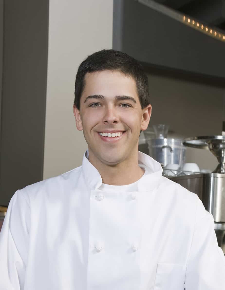 a private chef smiling in a kitchen.