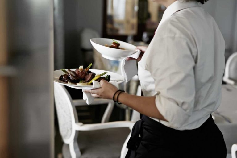 Private Chef services in wine country, waitstaff carrying food to table.