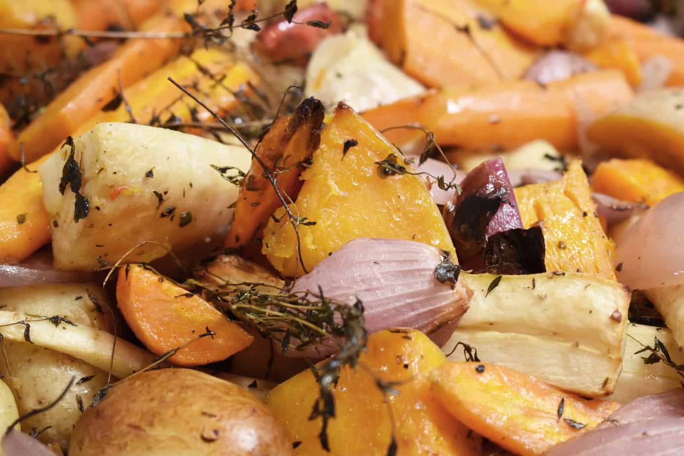 a close up vision of oven roasted vegetables with herbs