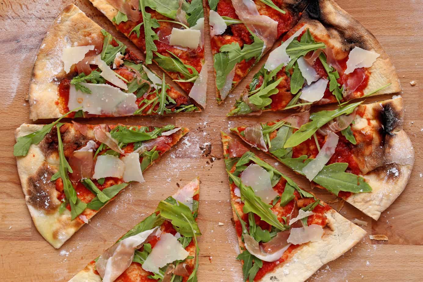 gourmet pizza on a wood cutting board