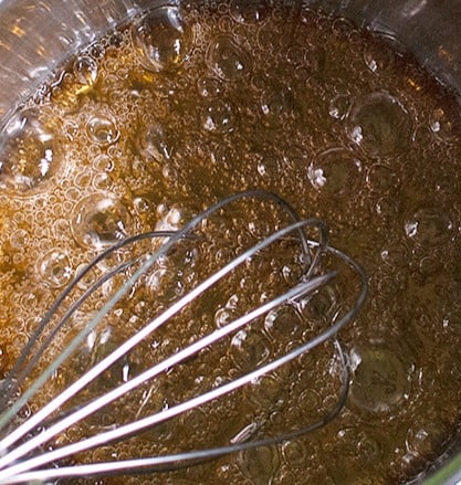 sugar changing to caramel in a pot on the stove