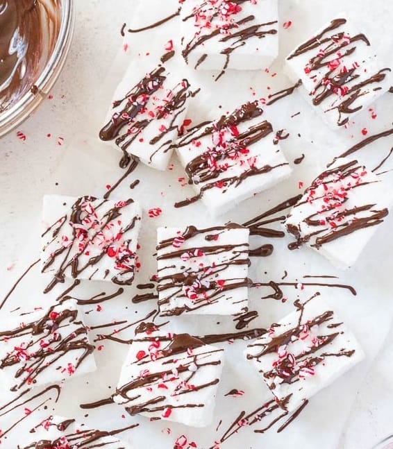 homemade marshmallows drizzled with chocolate and crushed peppermint candies