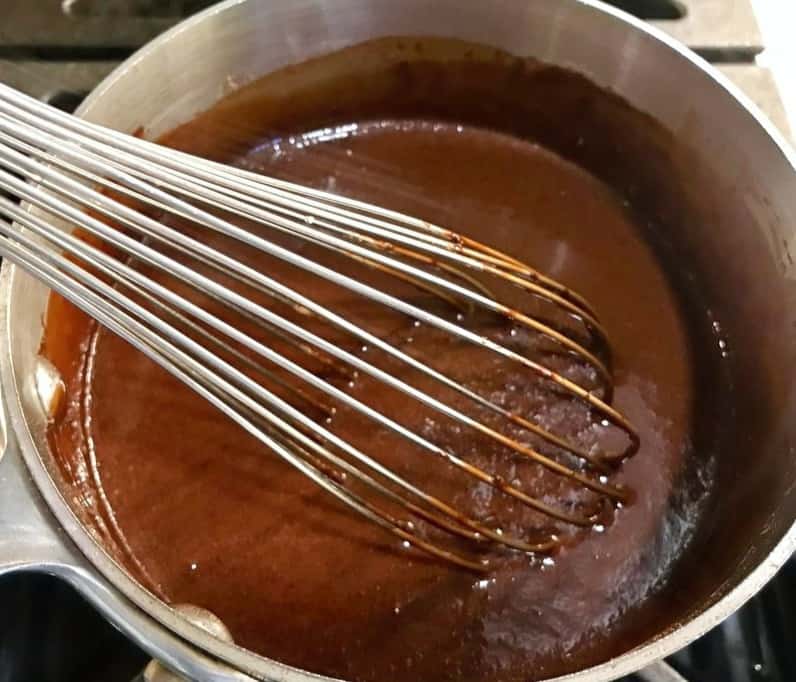 gourmet hot chocolate being whisked in a pan