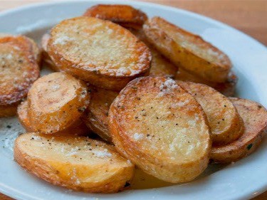 perfectly cooked skillet potatoes sprinkled with salt