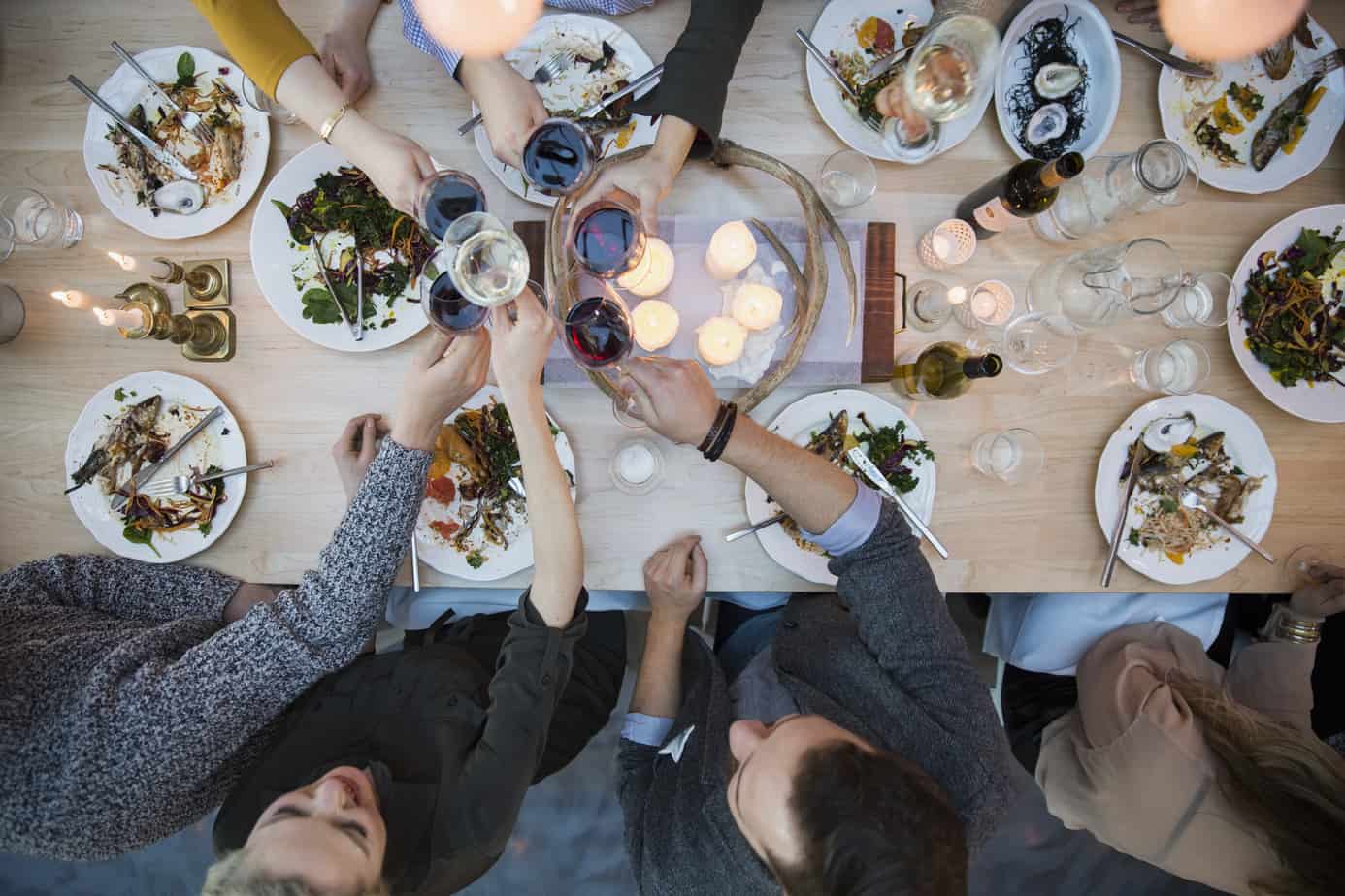 friends seated at a table enjoying the best intimate dinner party at home.