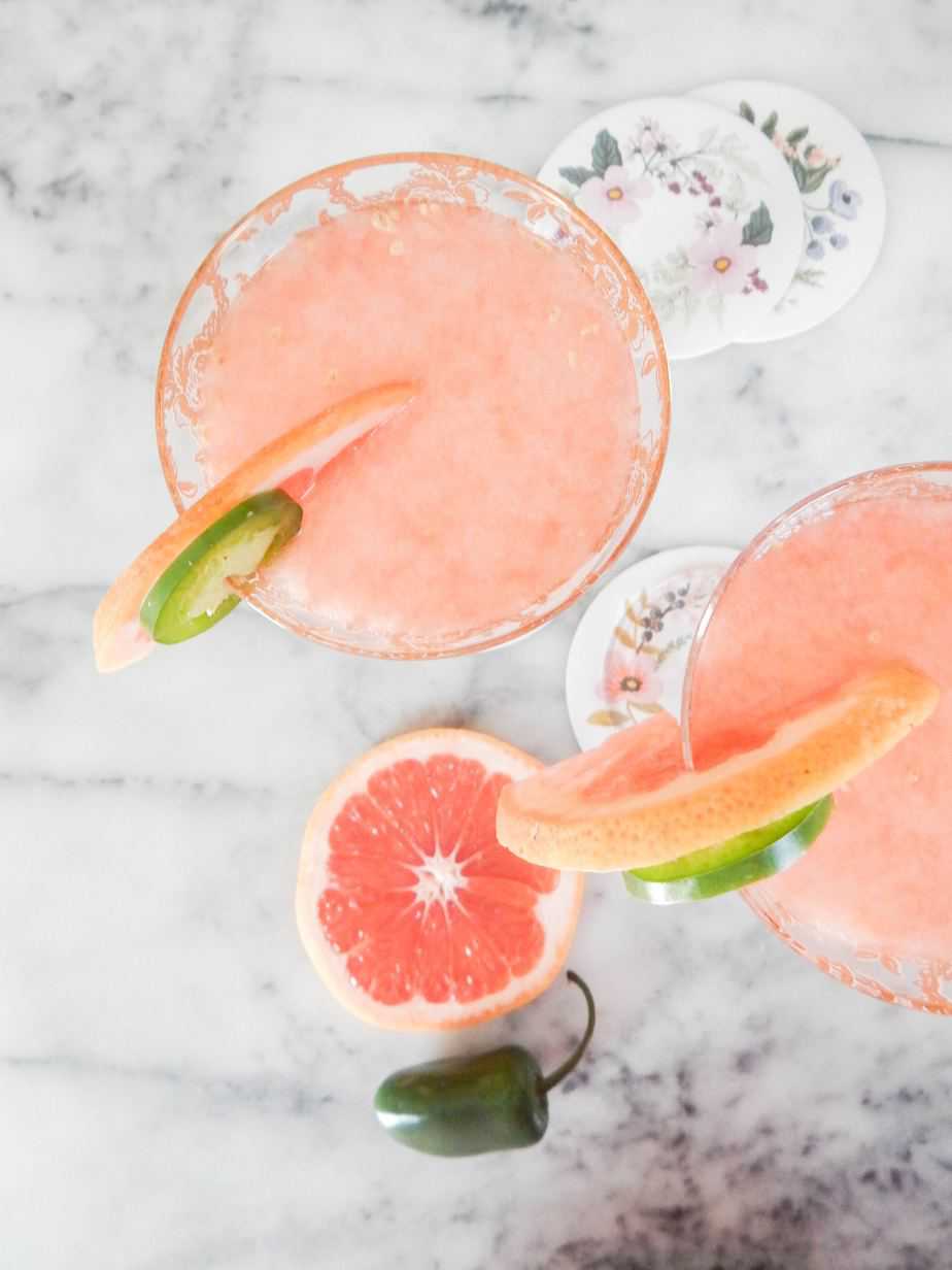 little hot pink dress cocktail served in a tall glass with fresh garnish