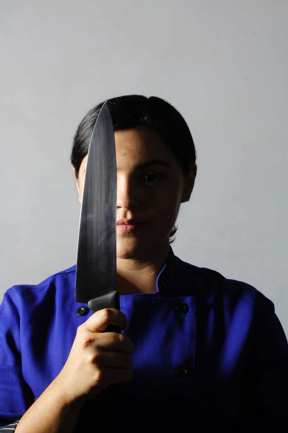 woman holding a chefs knife