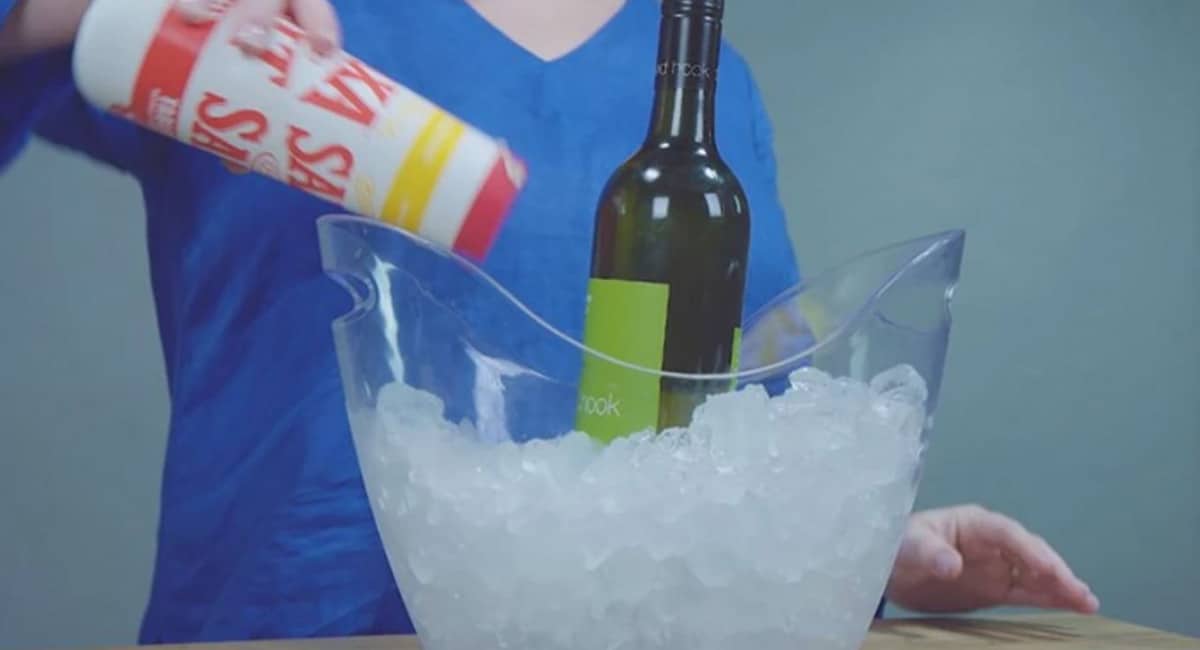 large ice bucket, filled with ice and a bottle of wine.  Sprinkling salt over the ice to accelerate chilling.