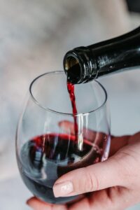 person pouring wine for a wine tasting class