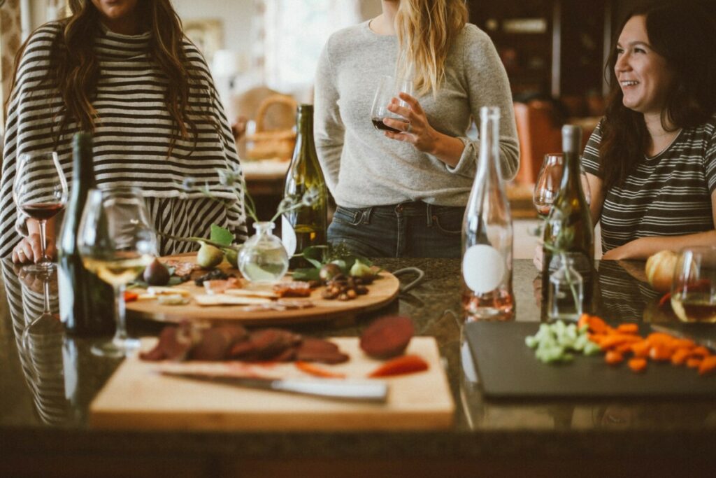 women enjoying easy effortless entertaining party with great food and wine shown